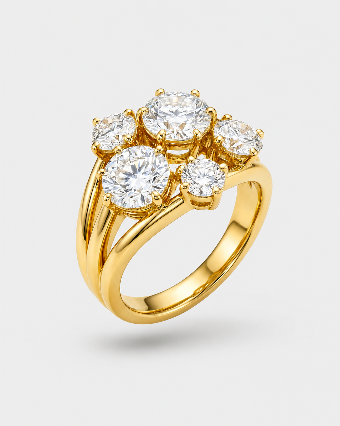 A yellow gold ring featuring a cluster of five round-cut diamonds in a floral-like setting, shown on a light gray background.