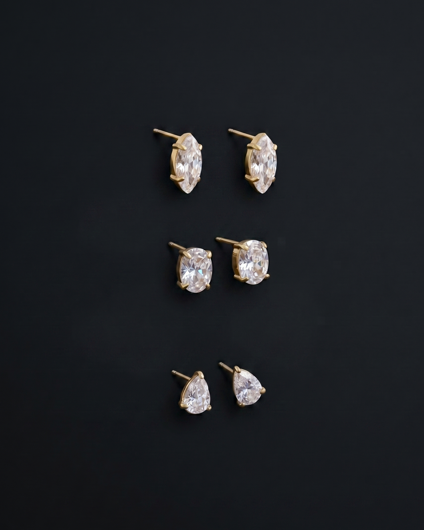 Set of diamond stud earrings on a black background