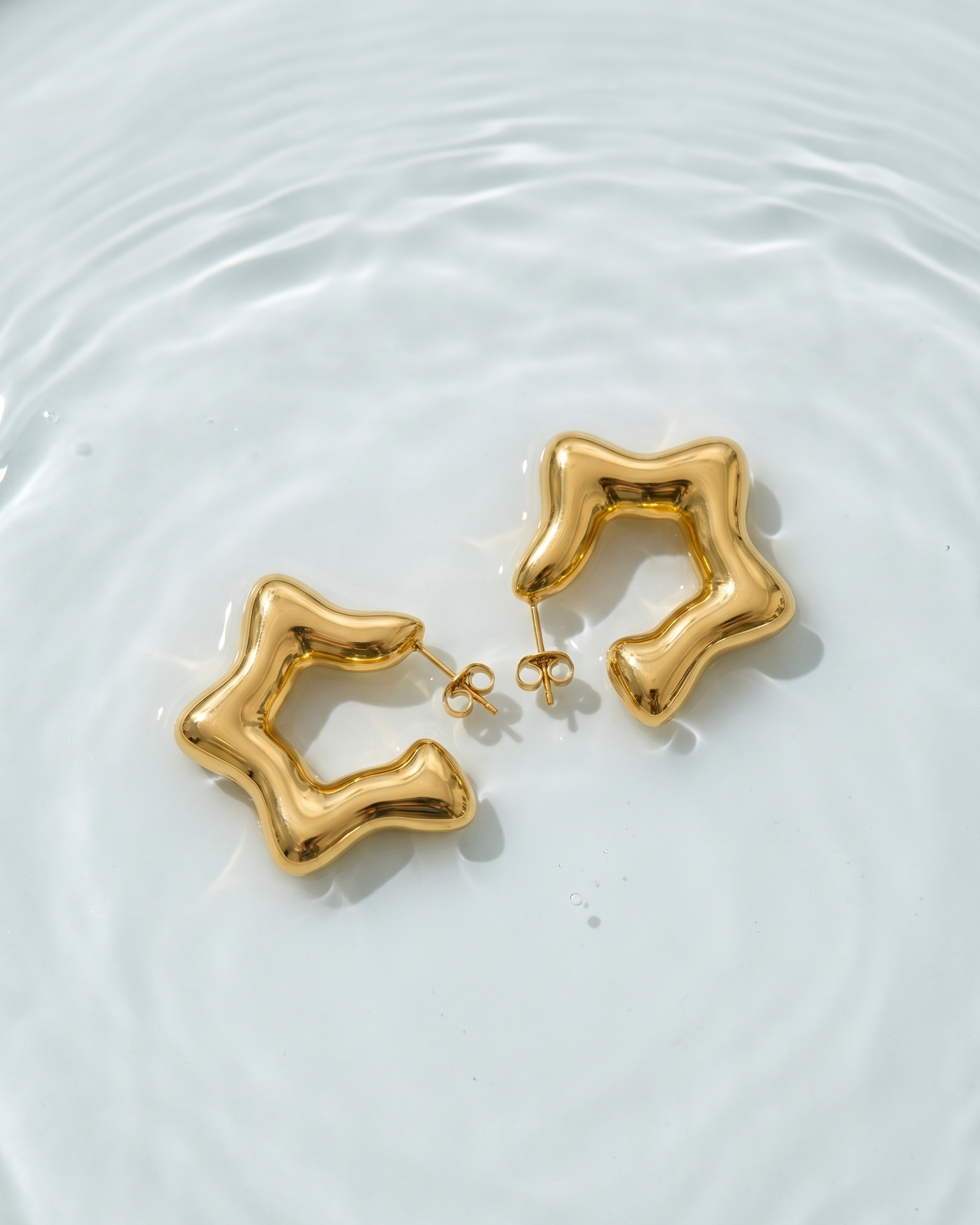 Gold earrings on a white background