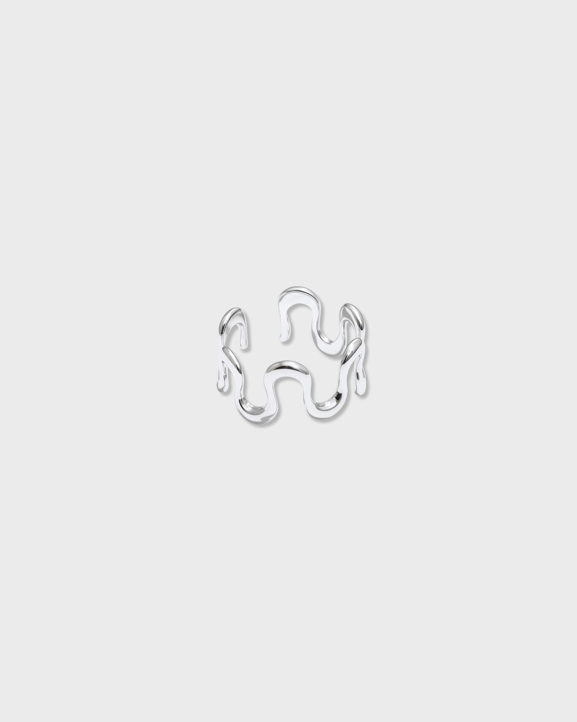 Silver ring with a unique design on a light gray background