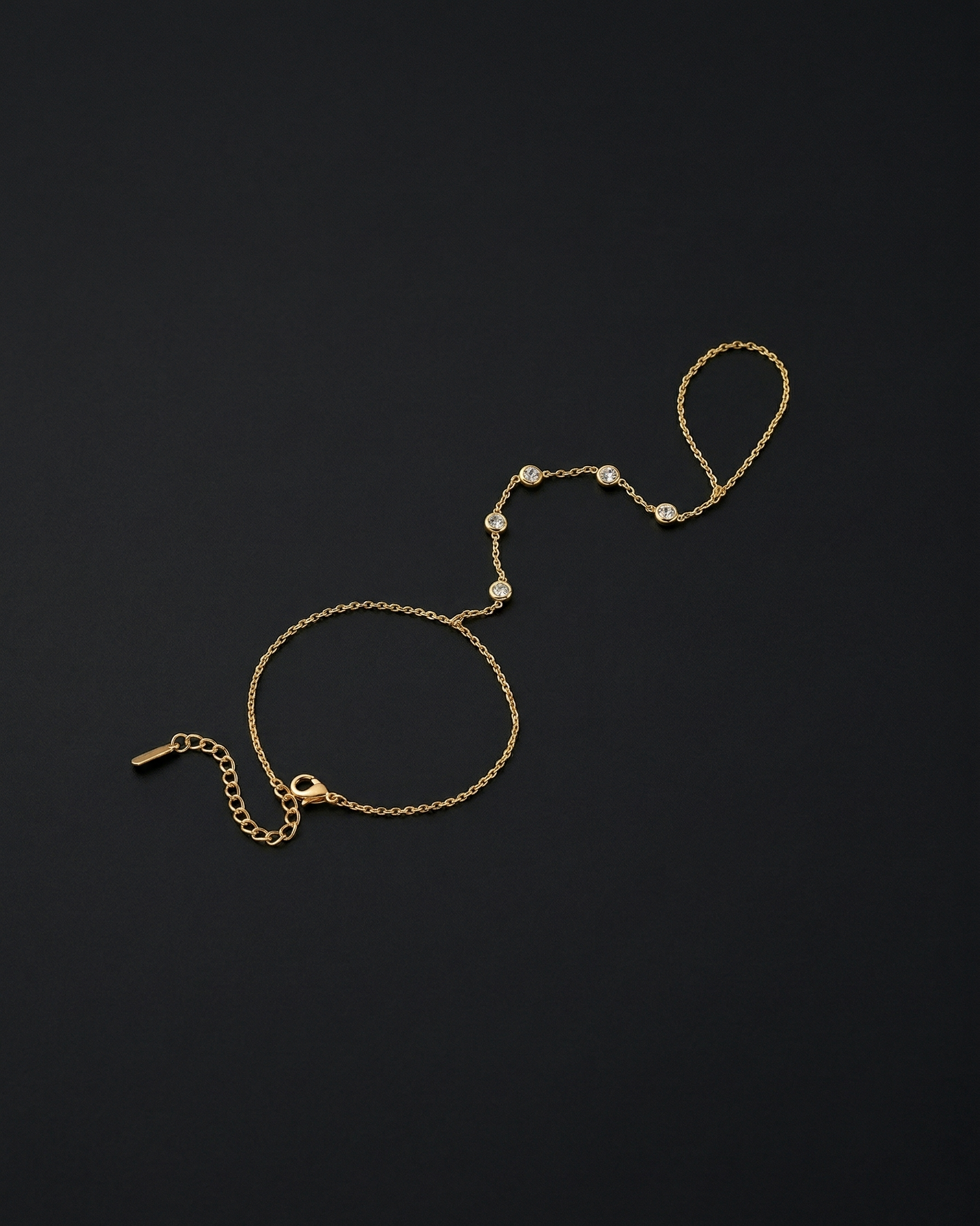 Gold bracelet with pearl-like beads on a black background