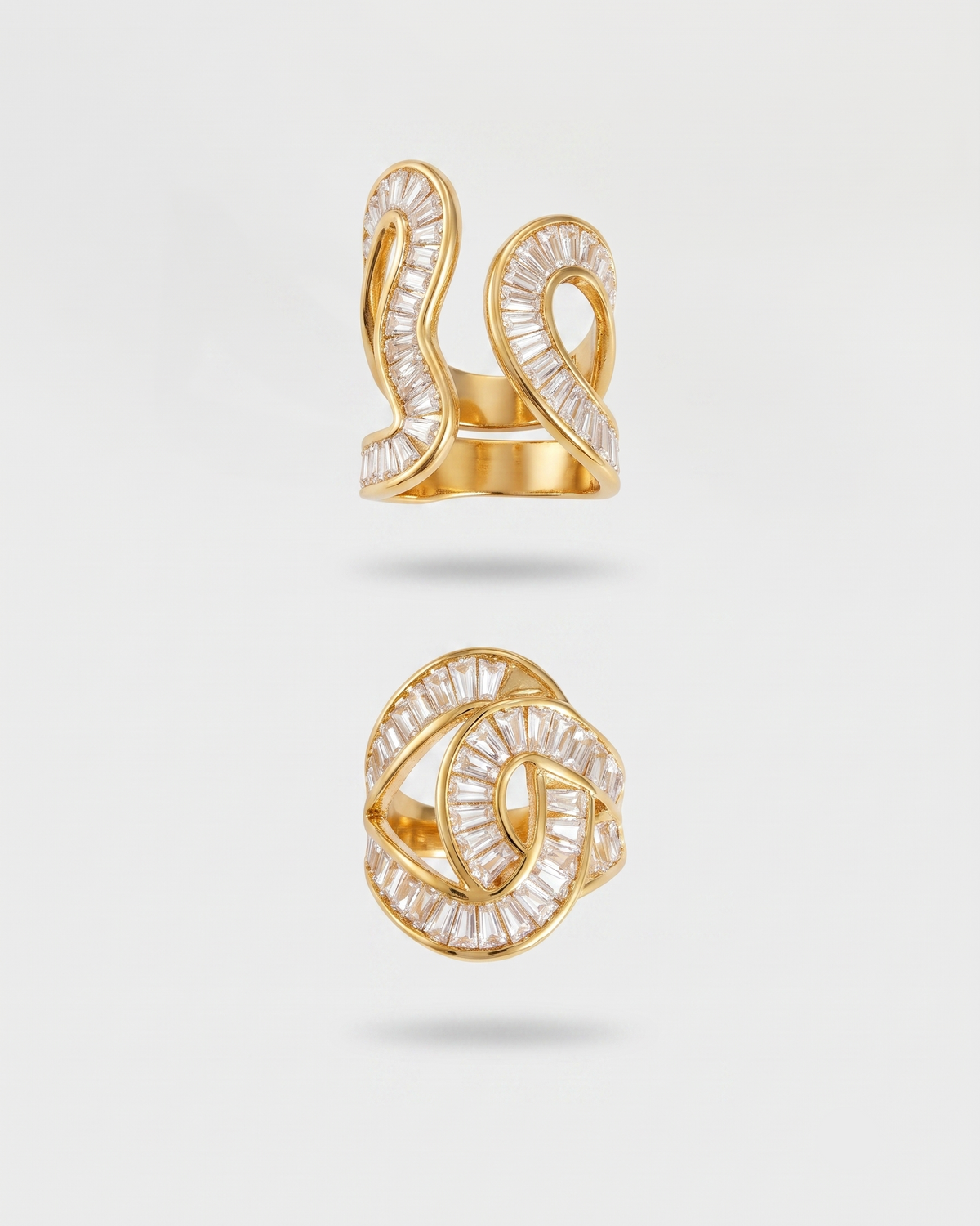 A gold ring with a double knot design, paved with clear baguette-cut diamonds, shown in two views against a light gray background.