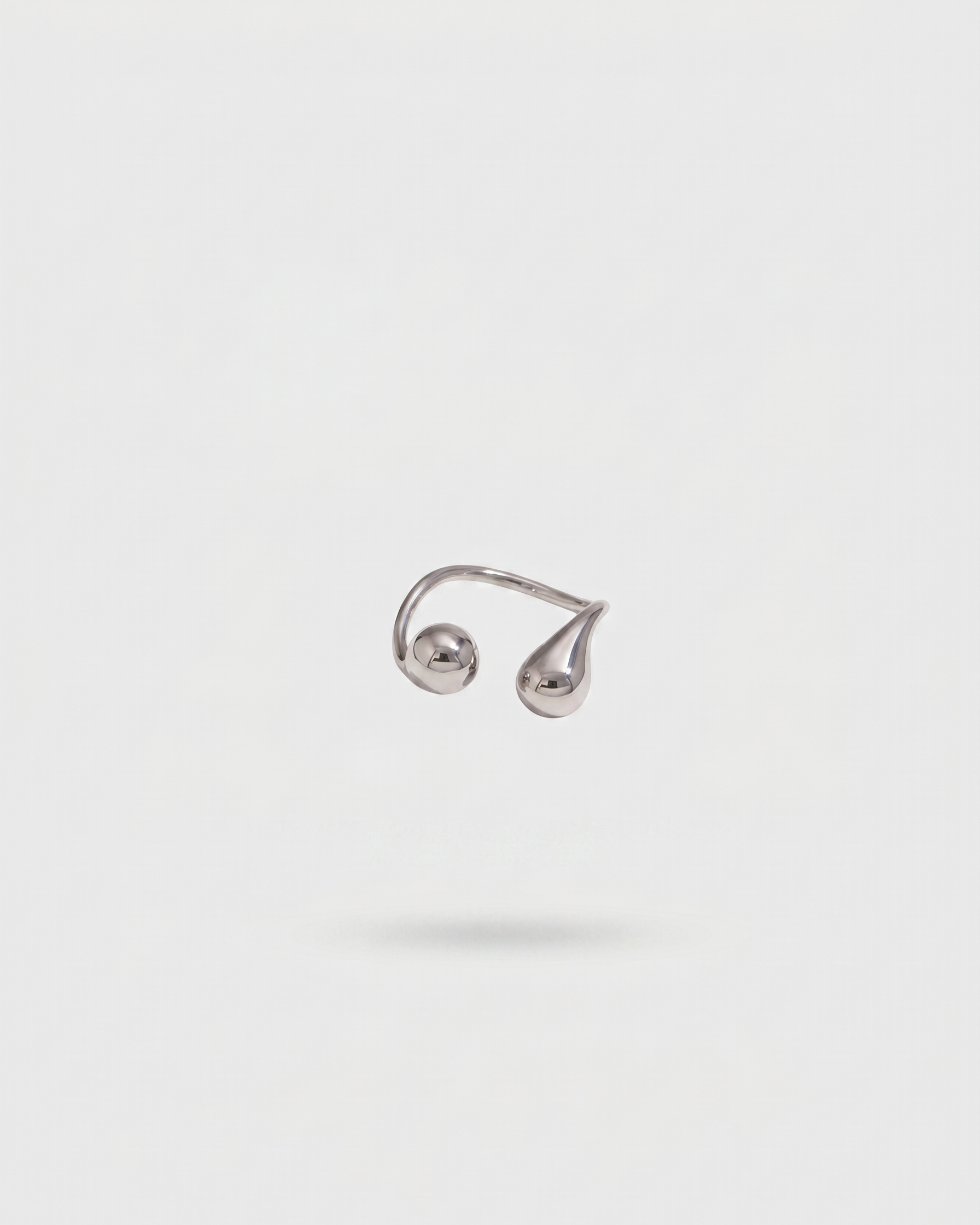 Silver ear cuff on a light gray background