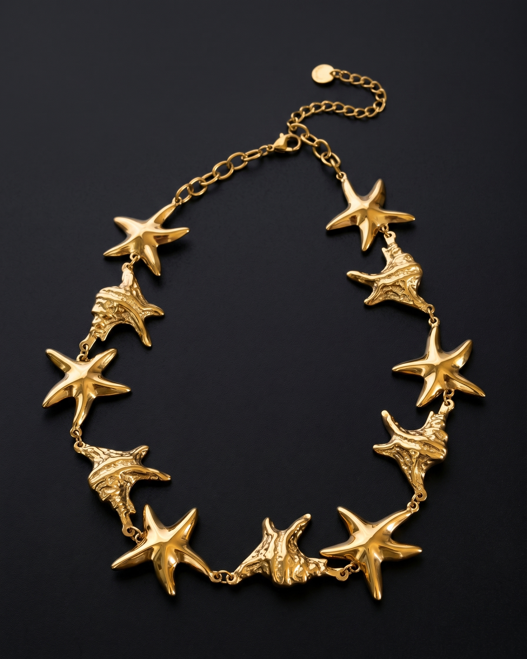 Gold starfish necklace on a black background