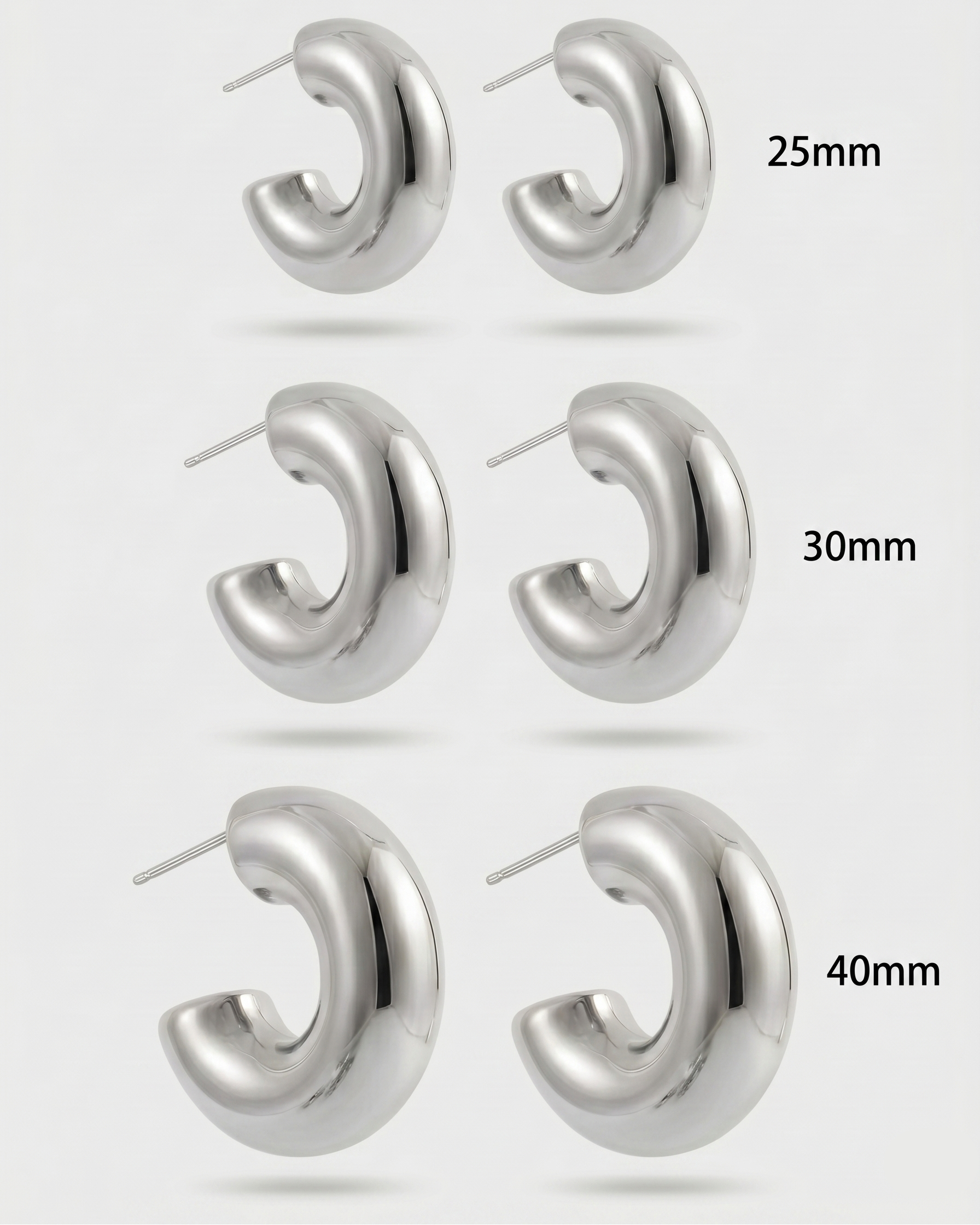 Silver hoop earrings in different sizes on a white background