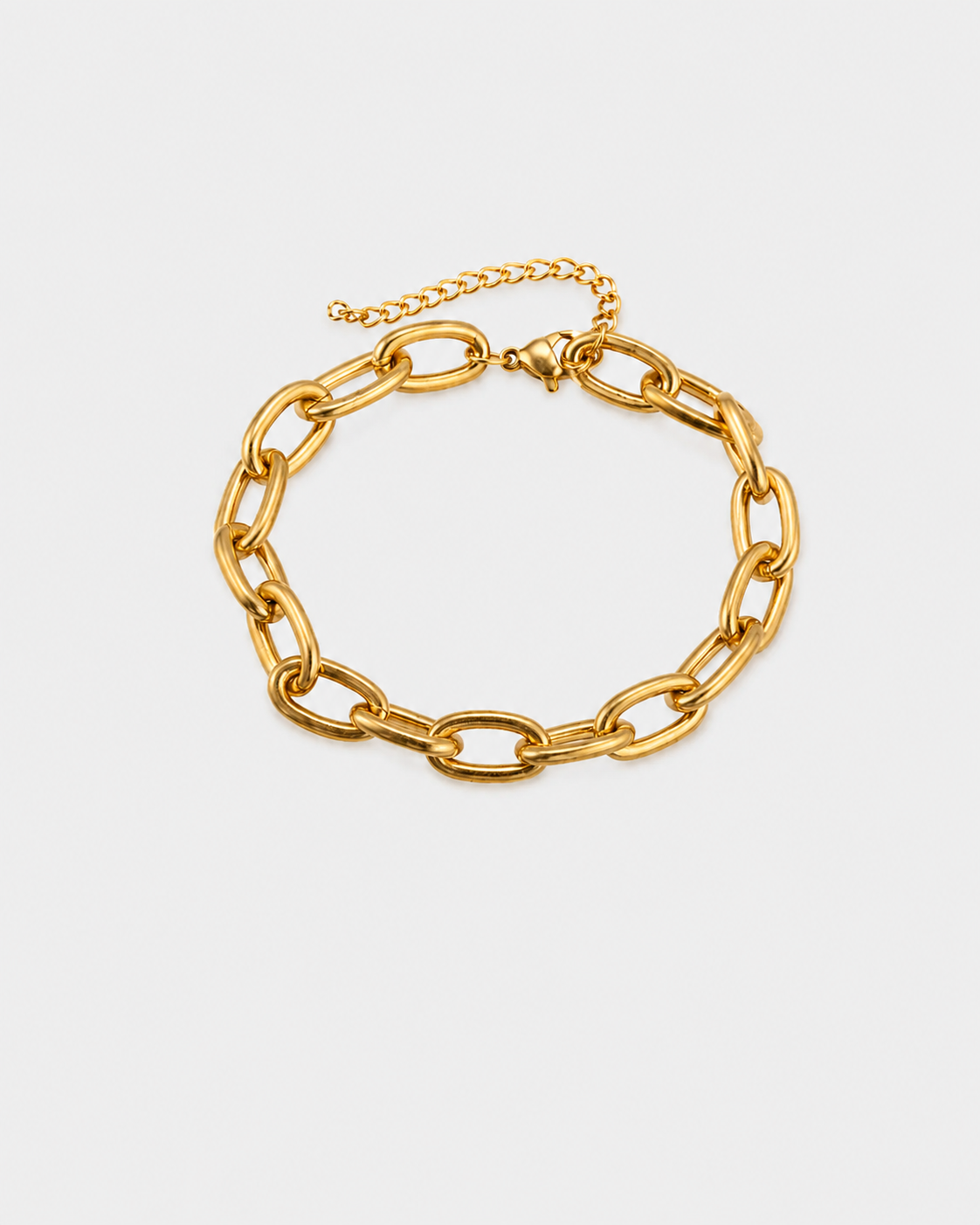 A gold-toned chunky chain link bracelet with a lobster clasp and an adjustable extender chain, displayed on a light gray background.