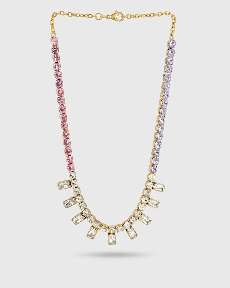 Necklace with pink and clear gemstones on a light gray background