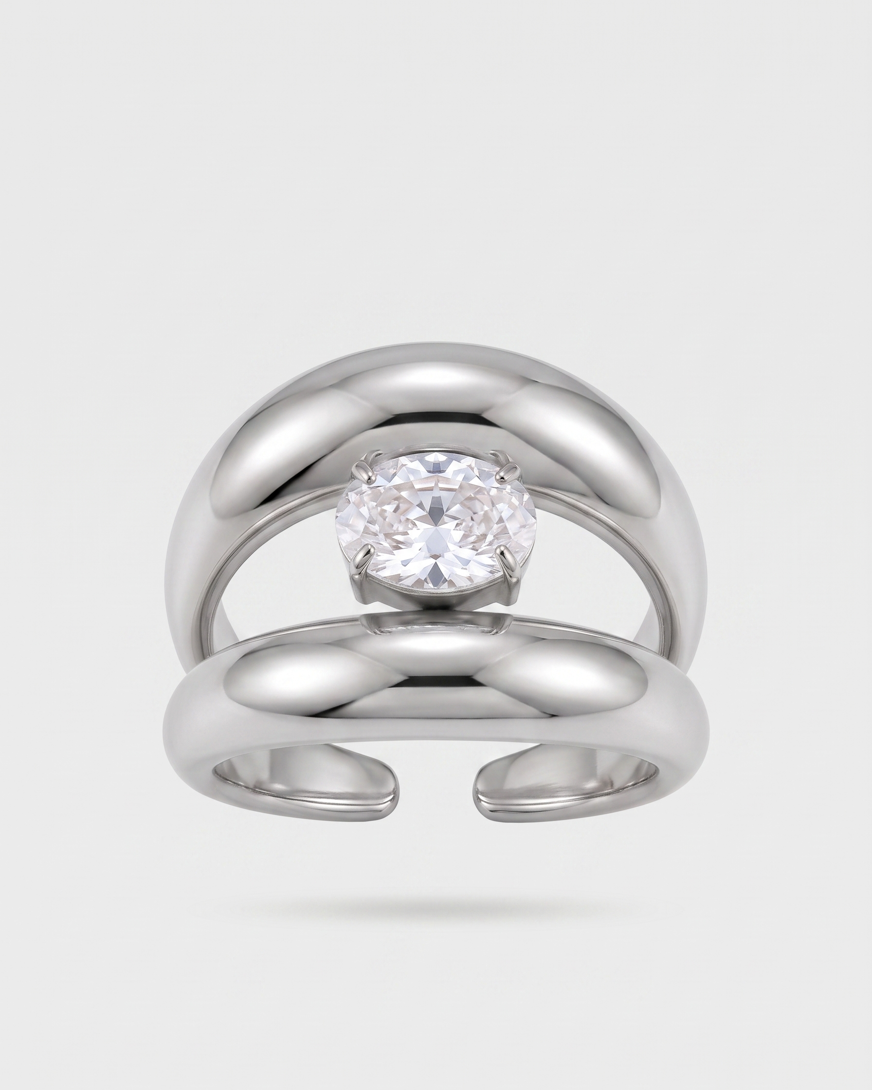 Silver ring with a diamond on a light gray background
