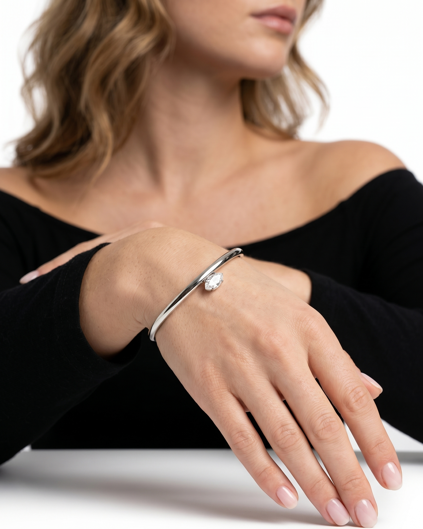 Woman wearing a silver bracelet on a white background