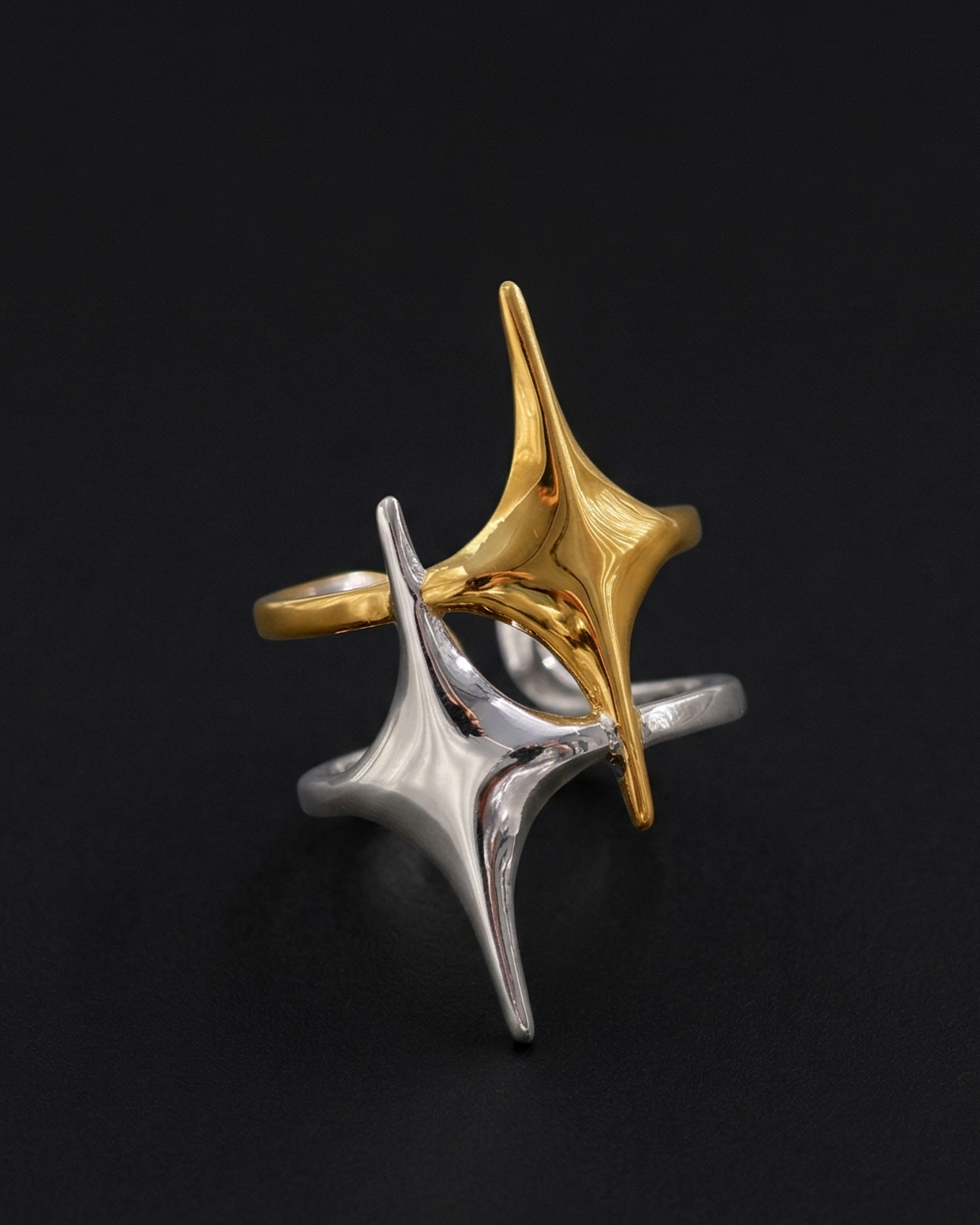 Two-tone star-shaped ring on a black background
