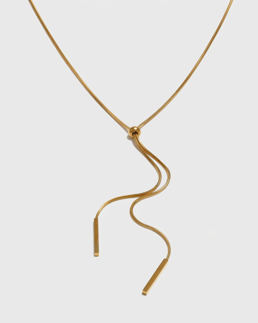 Gold necklace with a unique design on a white background