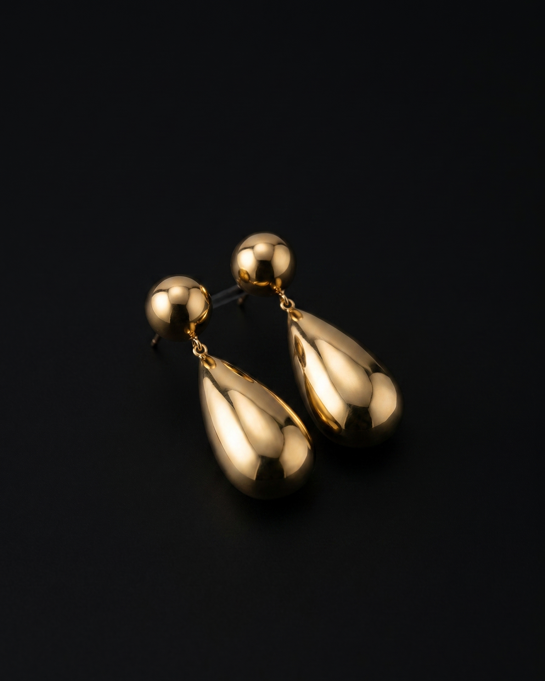 Gold earrings on a black background