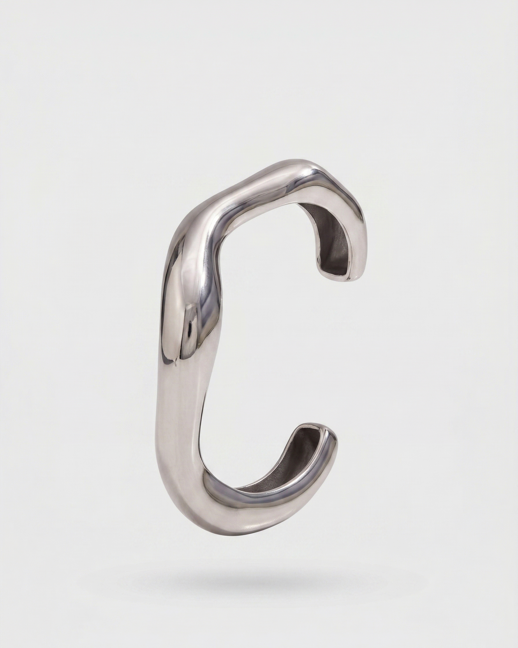 Silver ring with a unique design on a light gray background