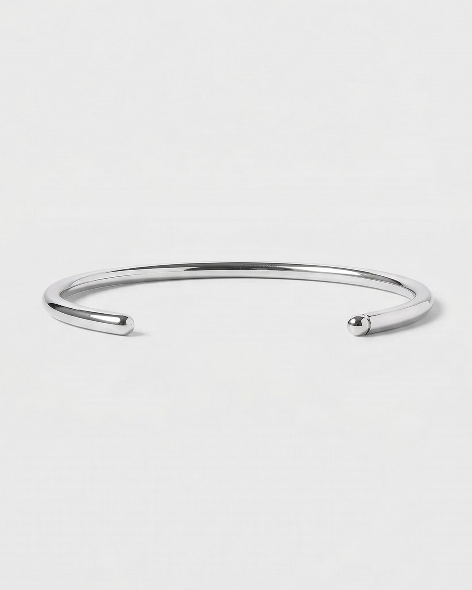 Silver bangle on a light gray background