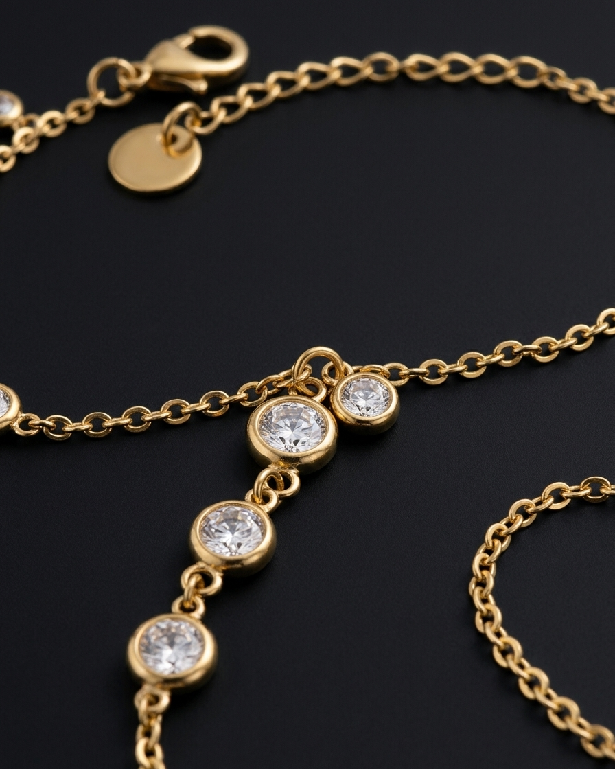 Gold bracelet with diamond-like stones on a dark background