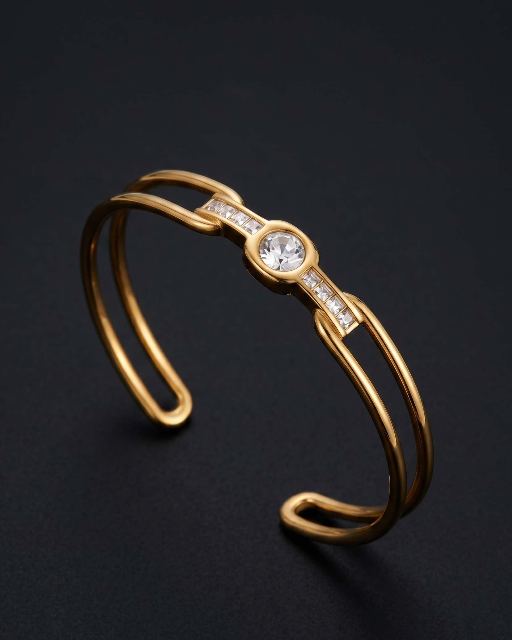 Gold bracelet with a central gemstone on a dark background