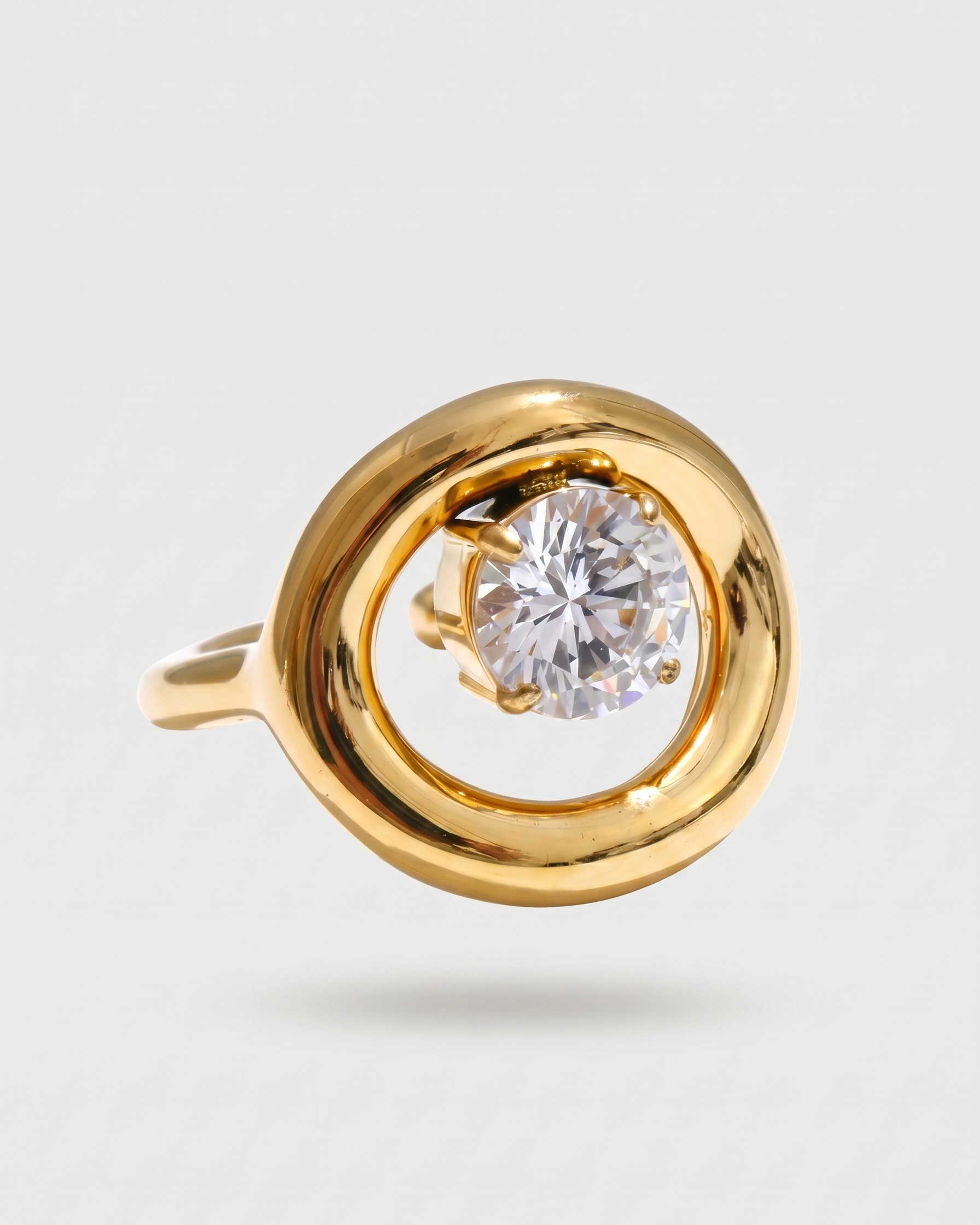 Gold ring with a diamond on a light gray background