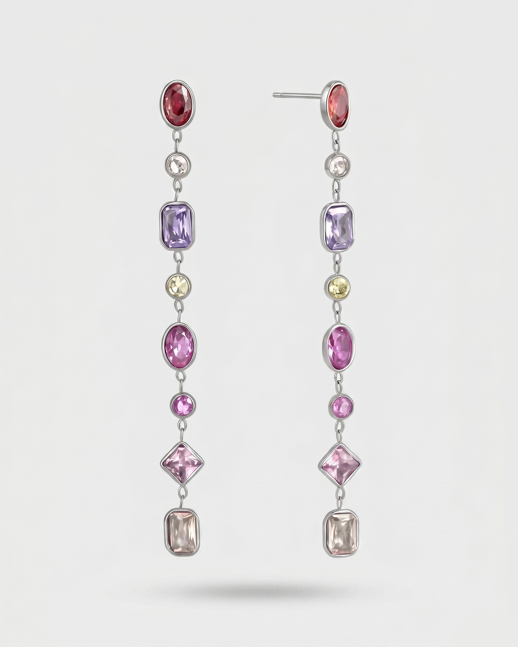 Earrings with multicolored gemstones on a white background