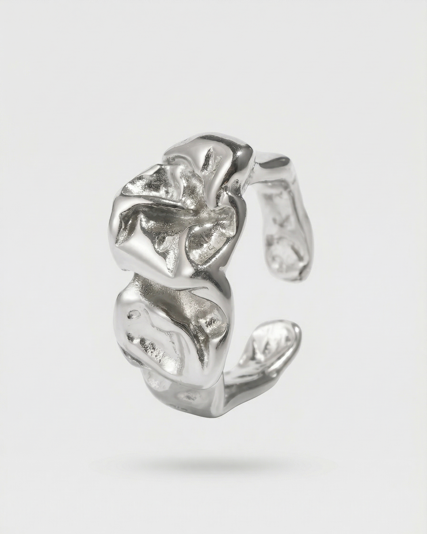 Silver floral ear cuff on a light gray background