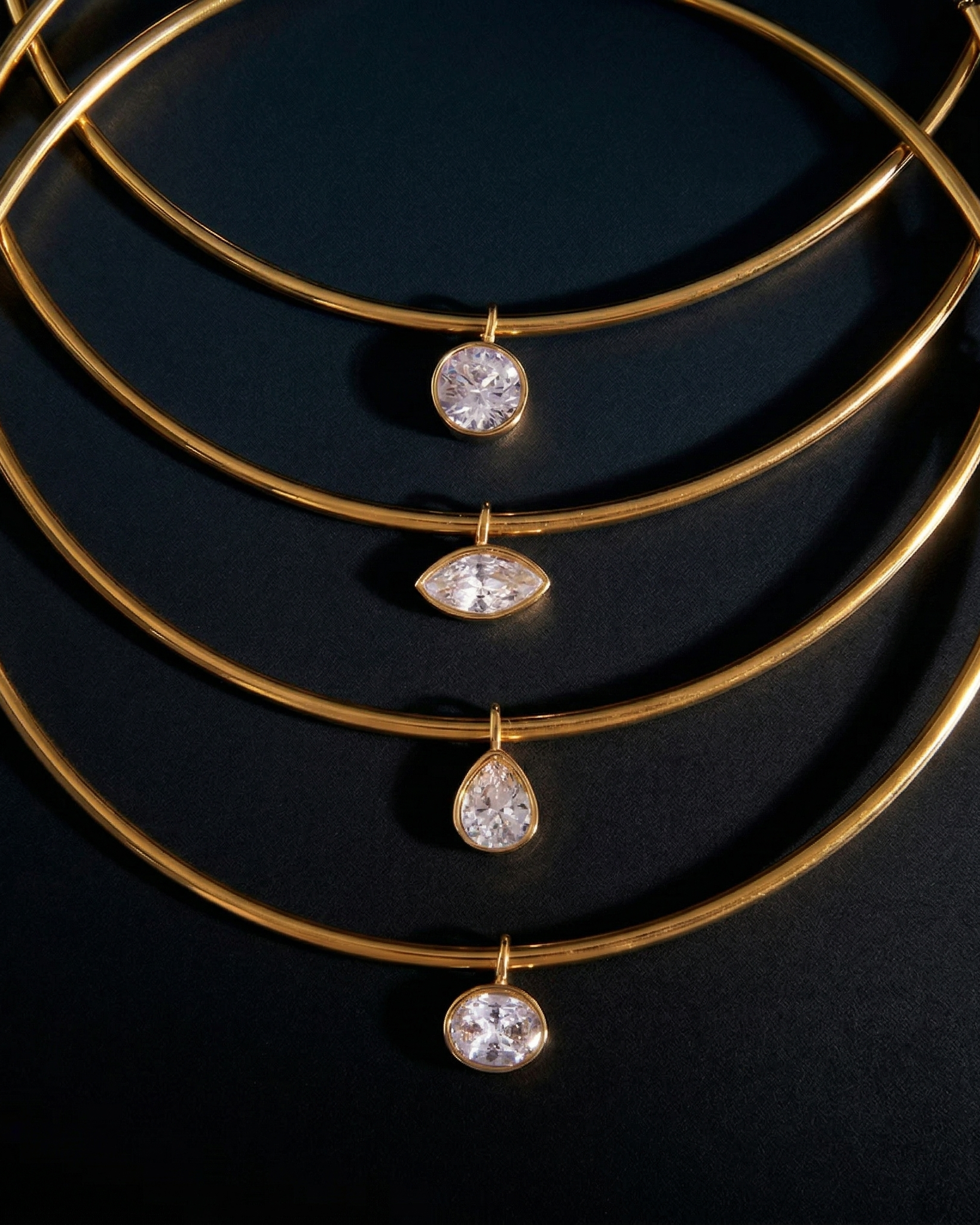 Gold necklace with diamond pendants on a dark background