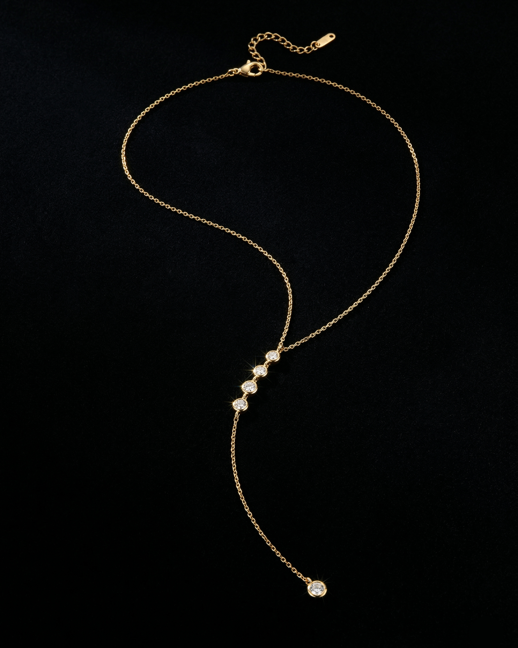 Gold necklace with small beads on a black background