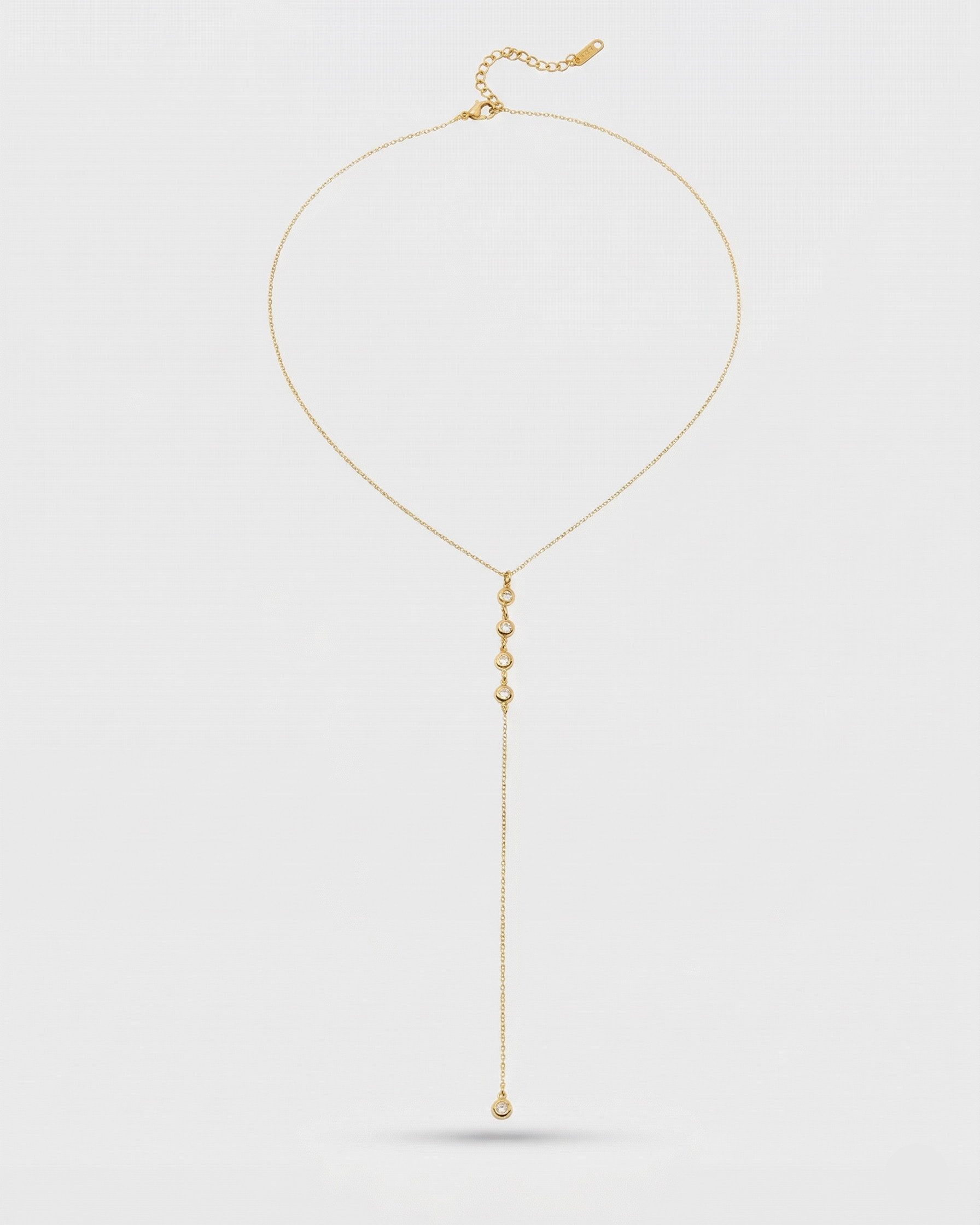Gold necklace with a pendant on a white background