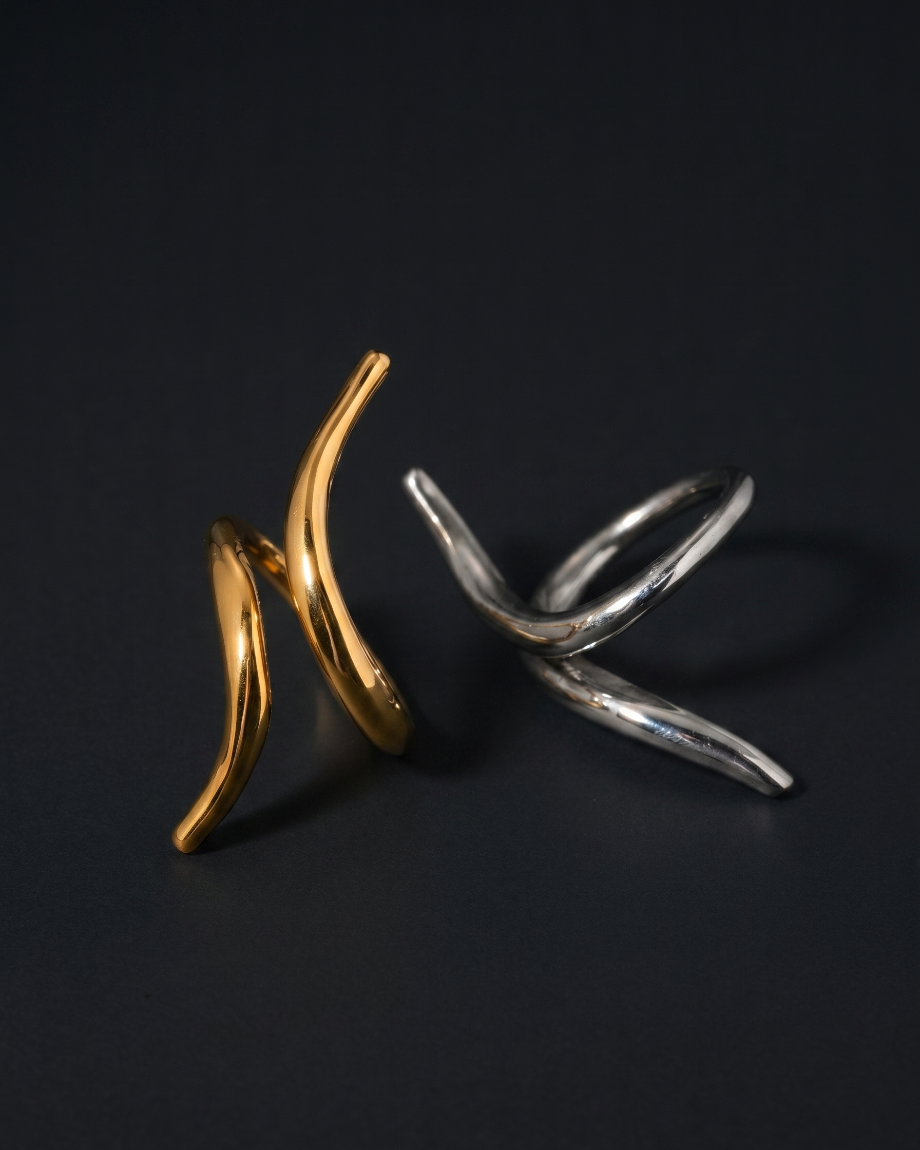 Gold and silver rings on a black background