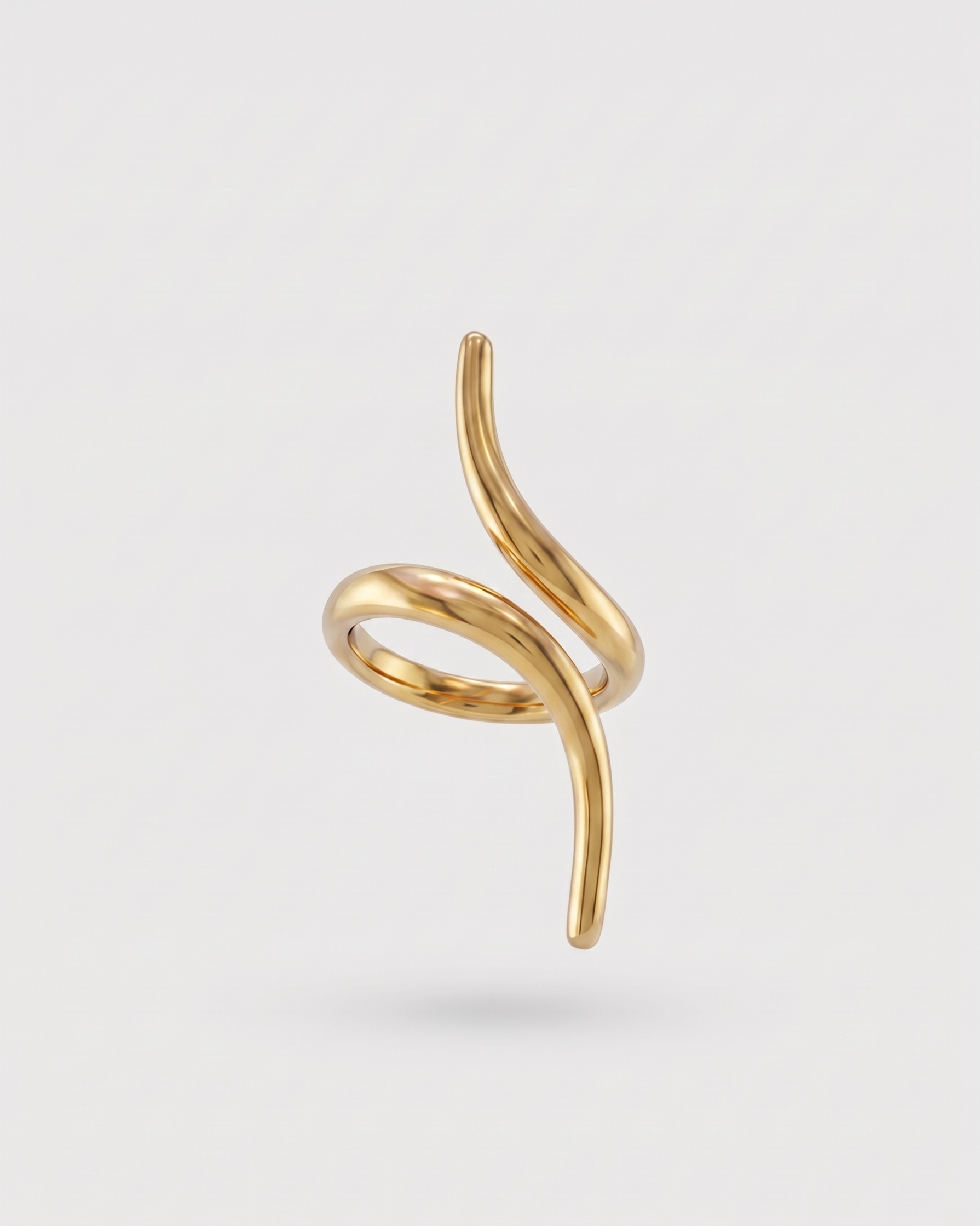 Gold spiral earring on a light gray background