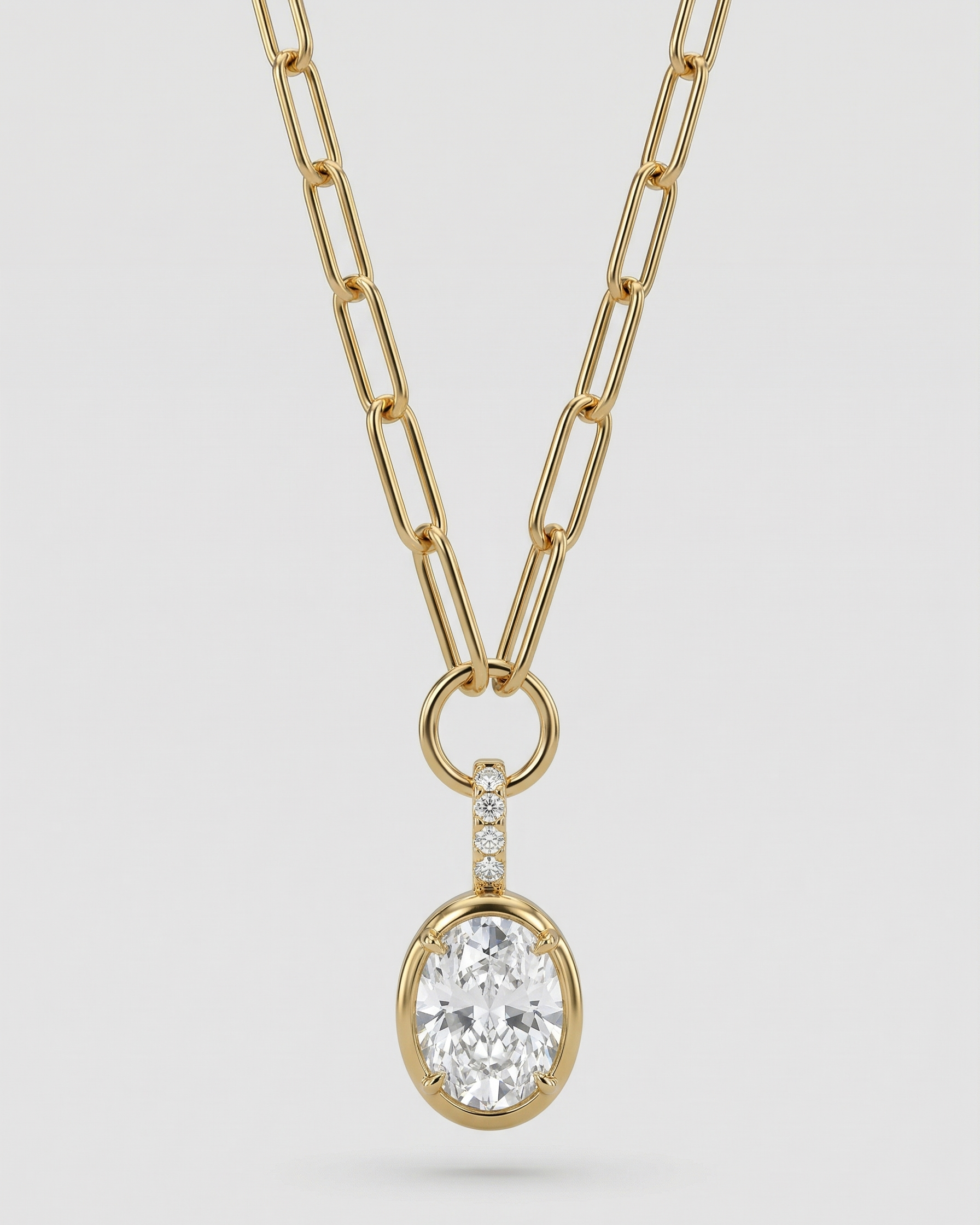 Gold necklace with a diamond pendant on a light gray background