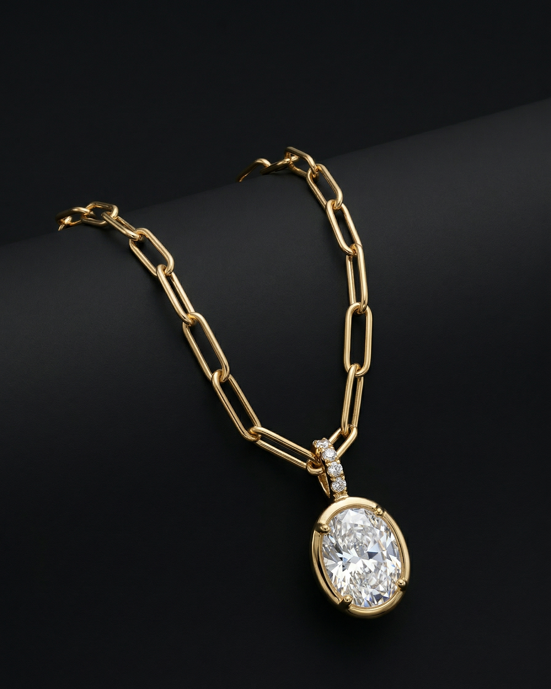 Gold necklace with a diamond pendant on a black background