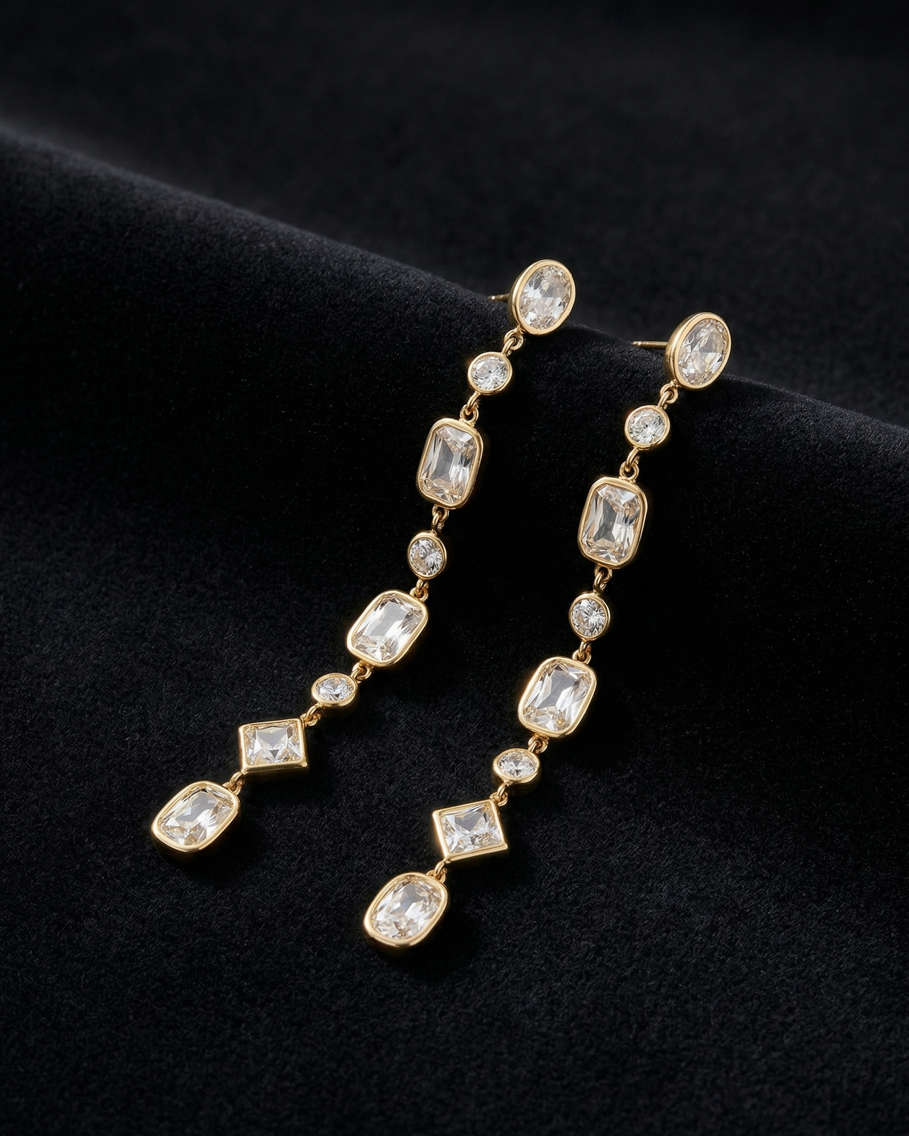Long diamond earrings on a black background