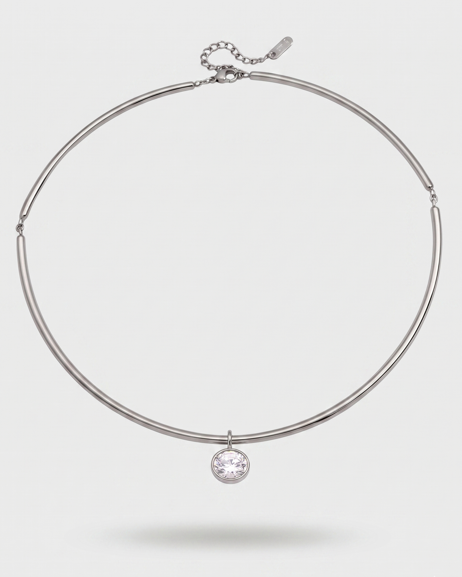 Silver necklace with a round pendant on a white background
