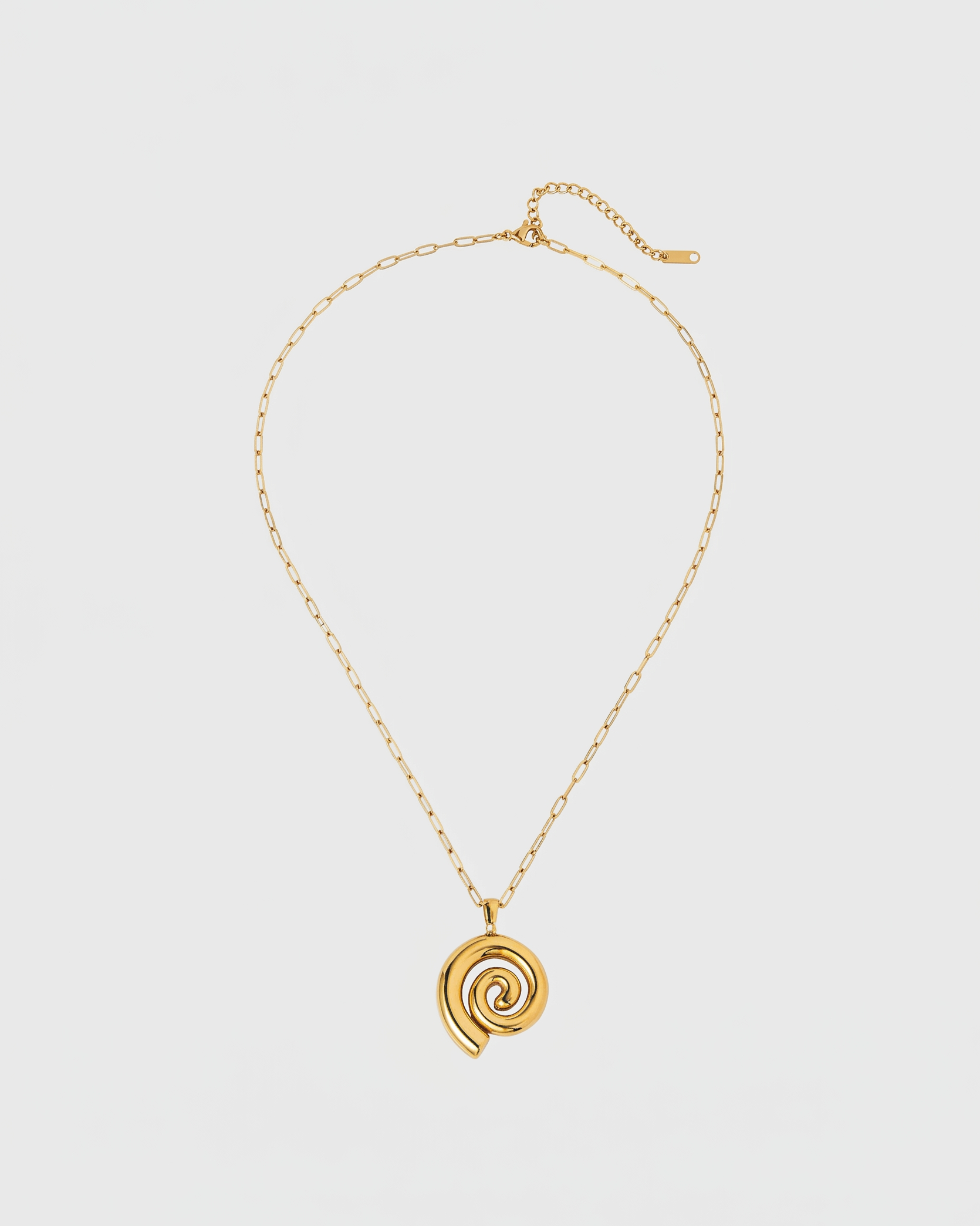 Gold necklace with a spiral pendant on a light gray background