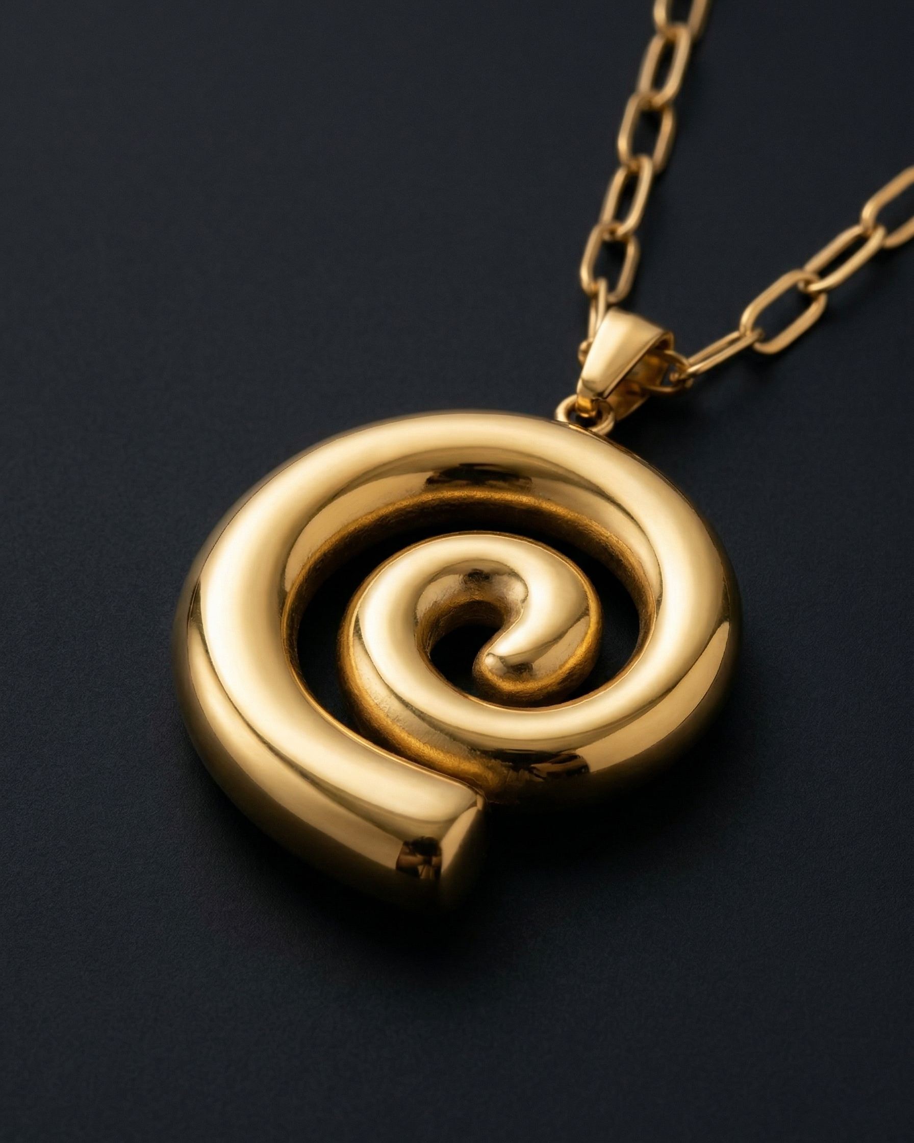 Gold spiral pendant necklace on a black background