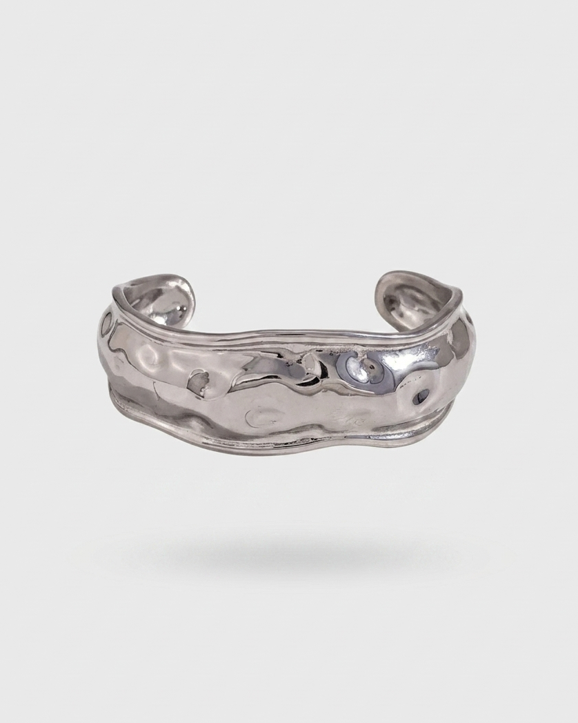 Silver bracelet on a light gray background