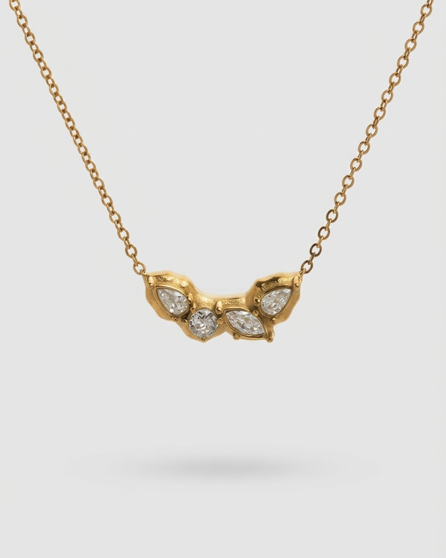 Gold necklace with a unique pendant on a light gray background