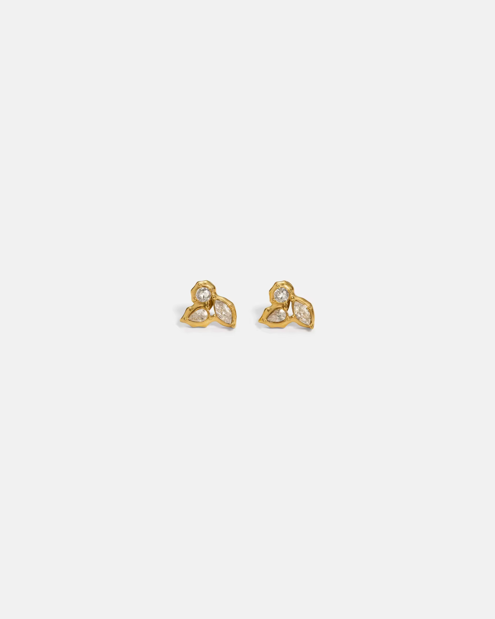 Pair of gold earrings with a white background