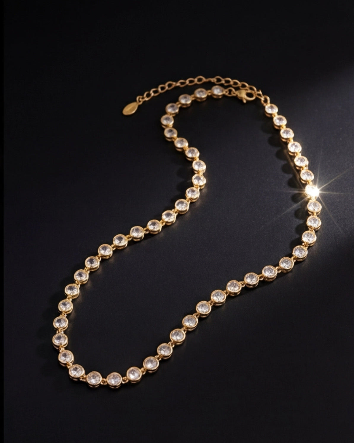 Gold necklace with clear stones on a black background