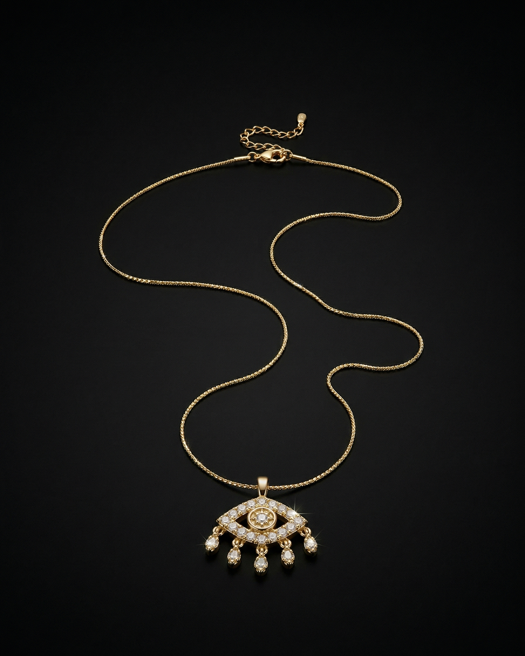Gold necklace with an eye-shaped pendant on a black background