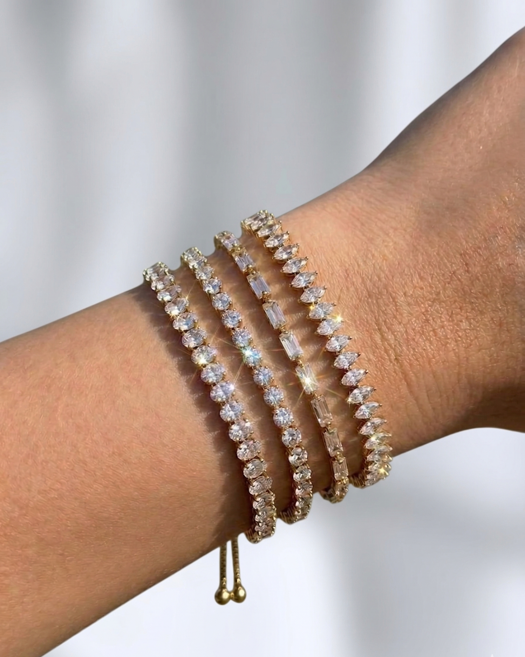 Beaded bracelets on a wrist with a neutral background
