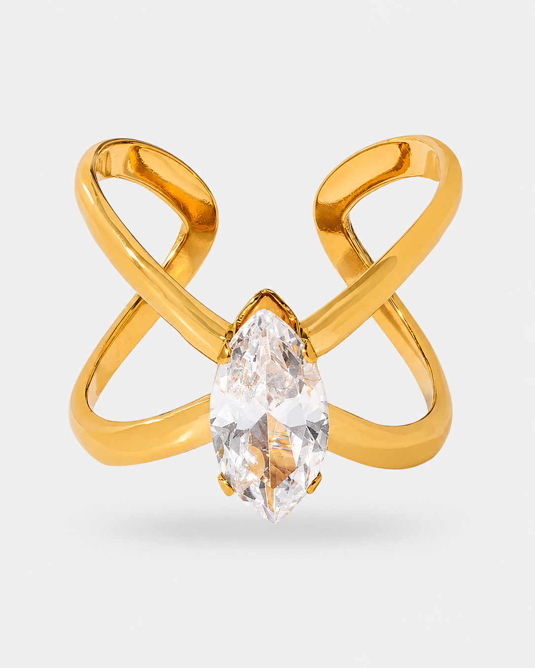 Gold ring with an infinity-shaped band and a marquise-cut clear gemstone in the center, shown on a light gray background.