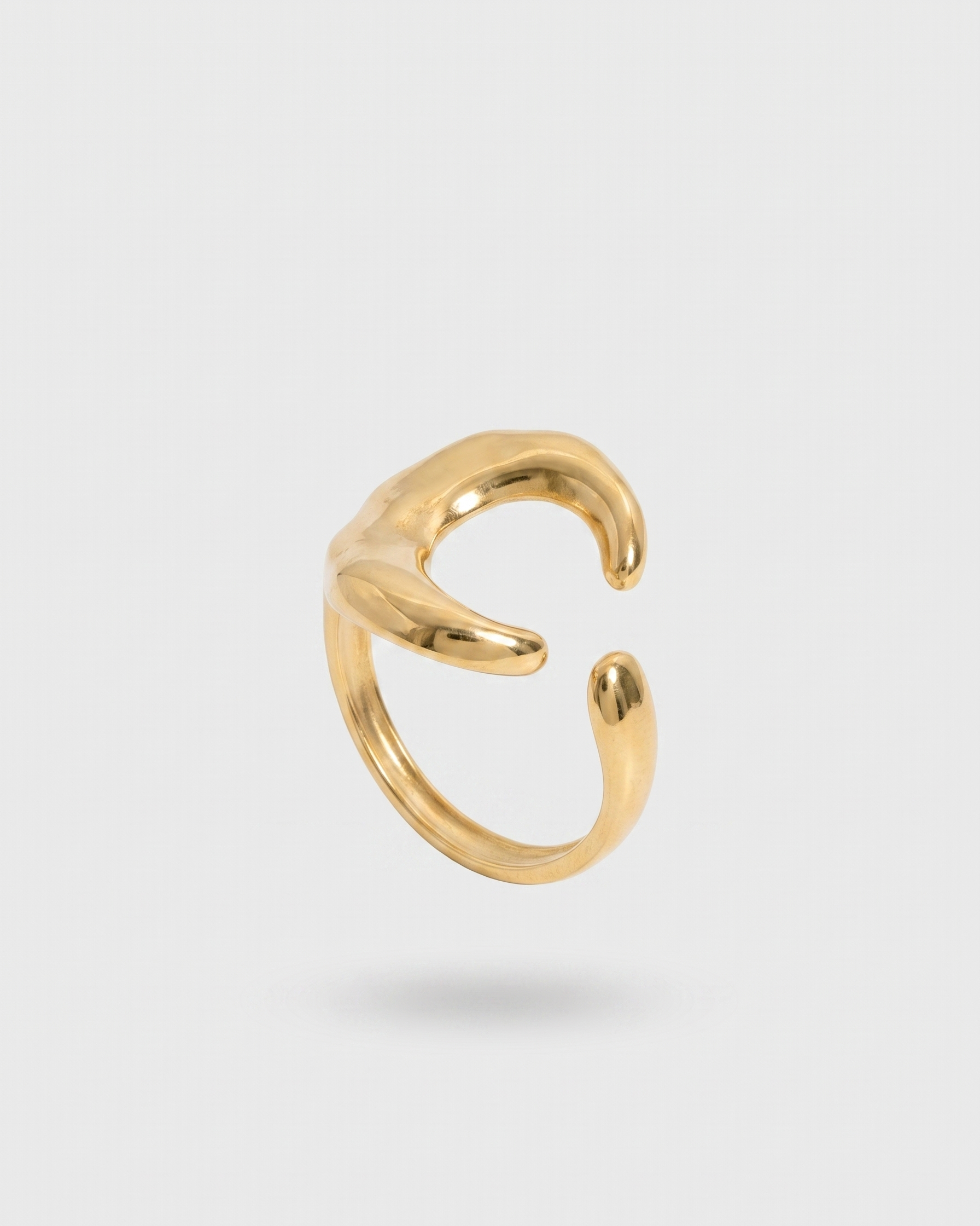 Gold moon ring on a light gray background