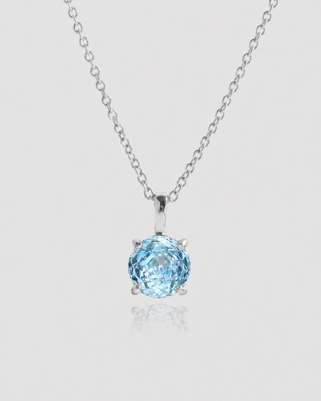 Blue gemstone necklace on a light gray background