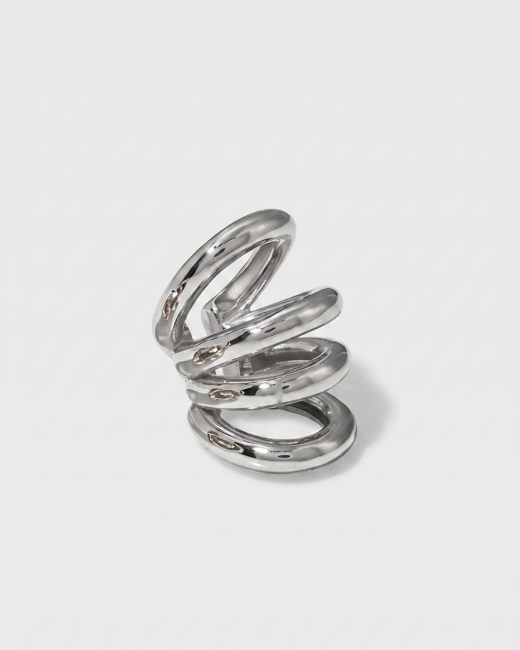 Silver spiral ring on a light gray background