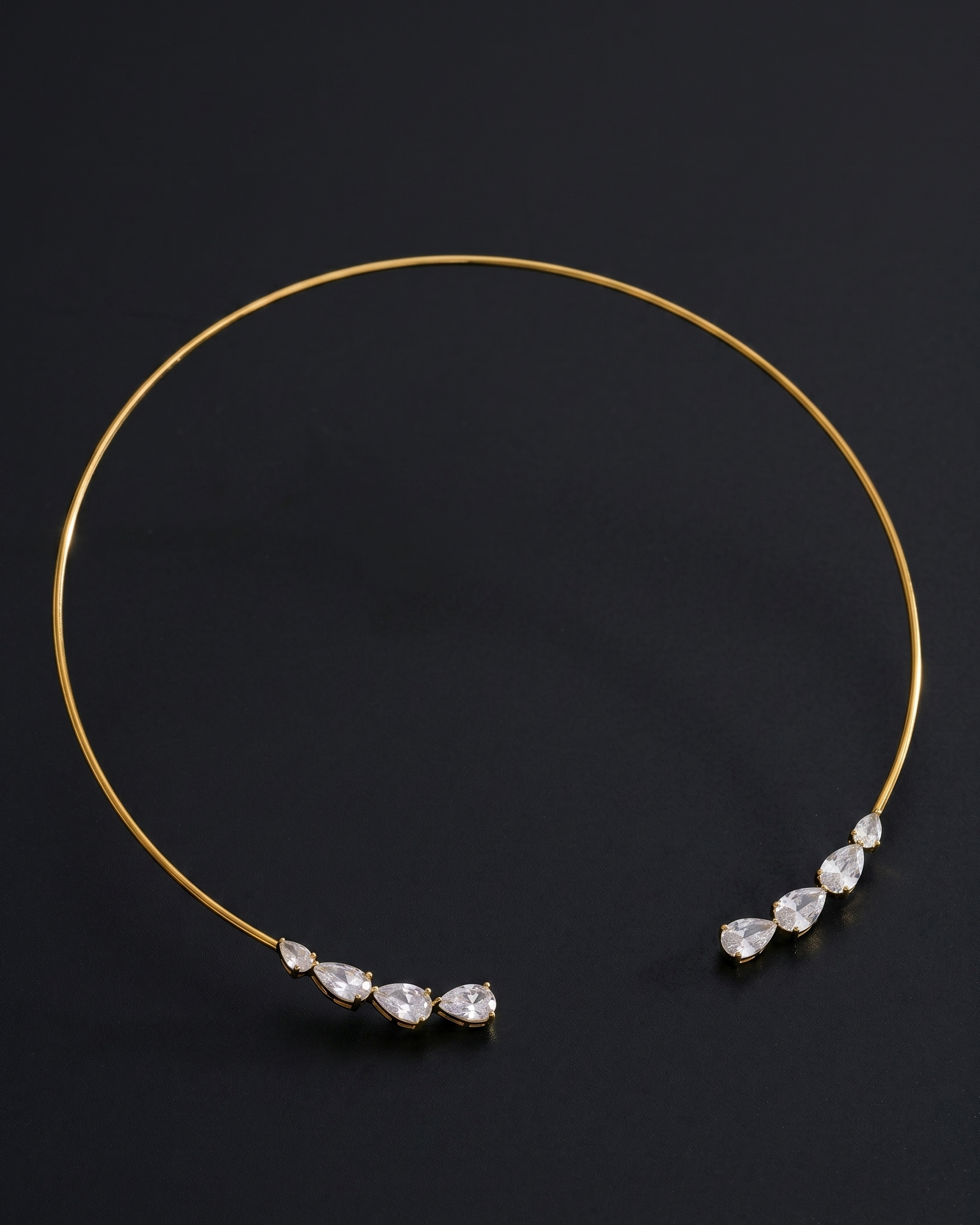 Gold headband with teardrop-shaped crystals on a black background