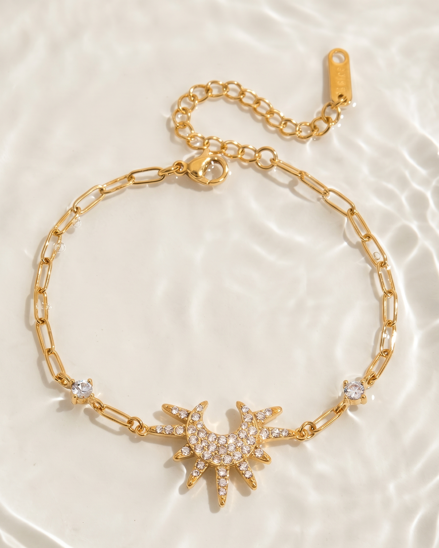 Gold bracelet with star design on a light background