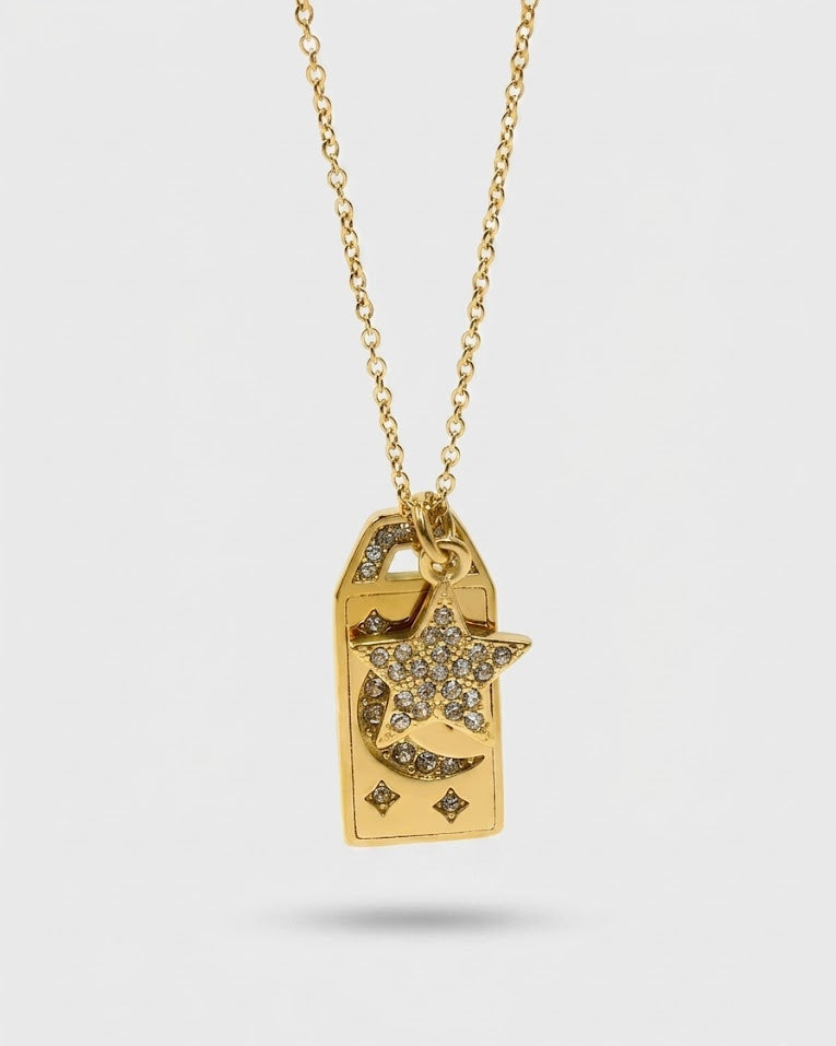 Gold necklace with a star-shaped pendant on a light gray background