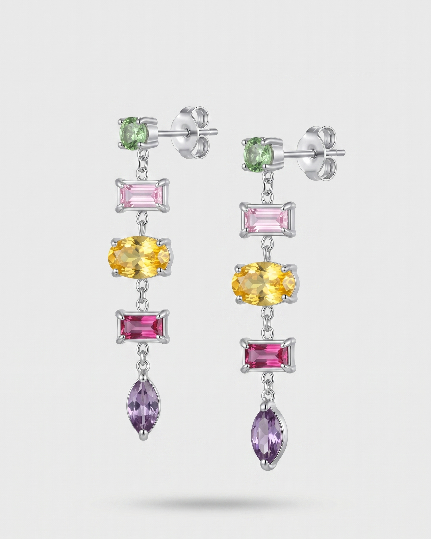 Multicolored gemstone earrings on a white background