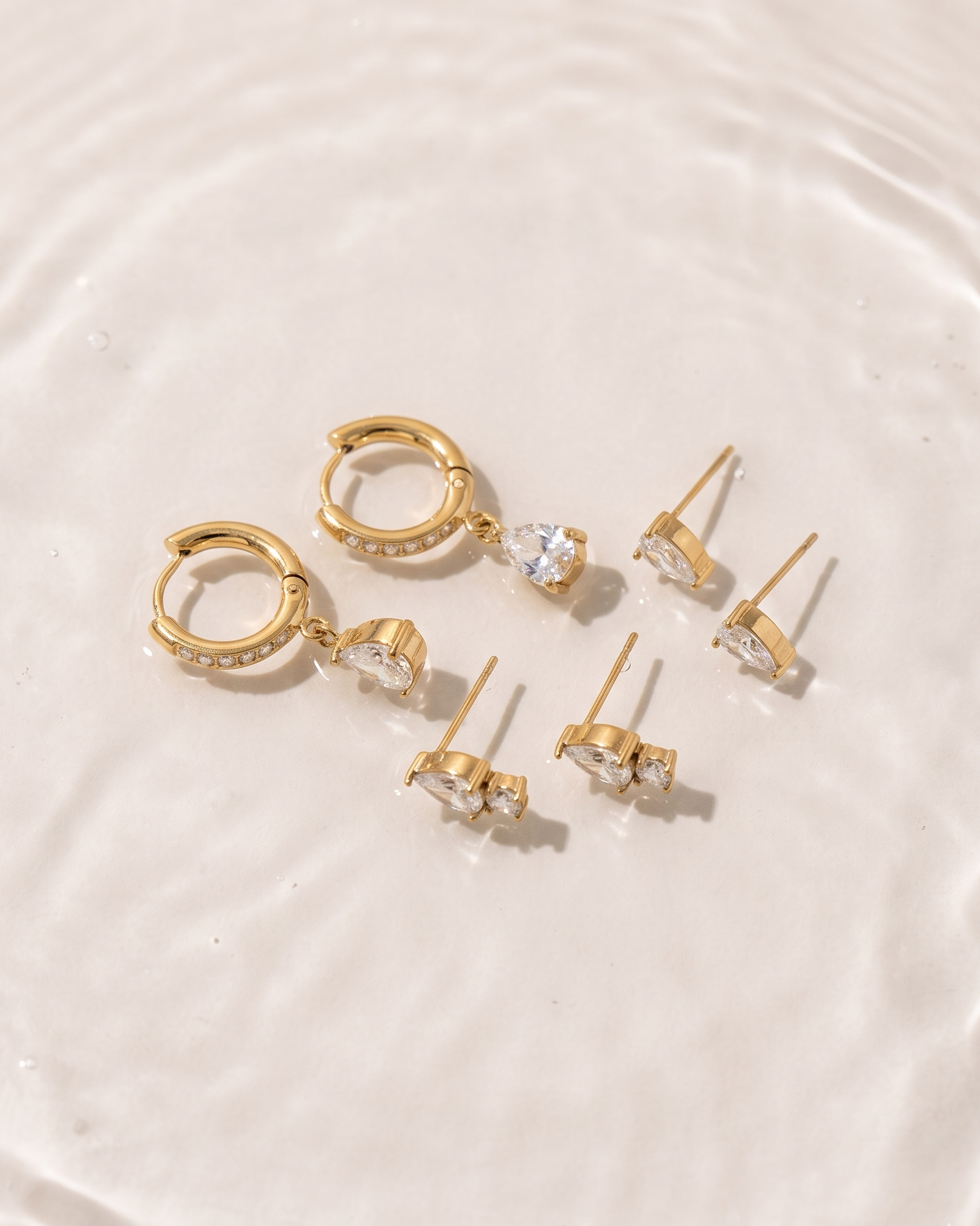 Set of gold earrings on a white background