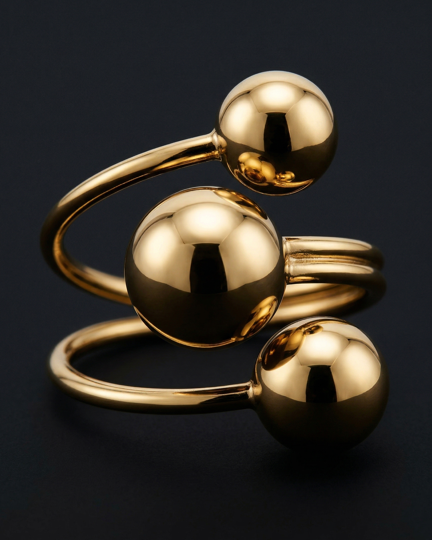 Gold bracelet with spherical links on a black background
